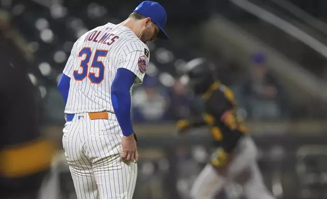 New York Mets pitcher Clay Holmes (35) reacts as Pittsburgh Pirates' Jared Triolo runs the bases after hitting a two-run home run during the fifth inning of a baseball game Wednesday, May 14, 2025, in New York. (AP Photo/Frank Franklin II)