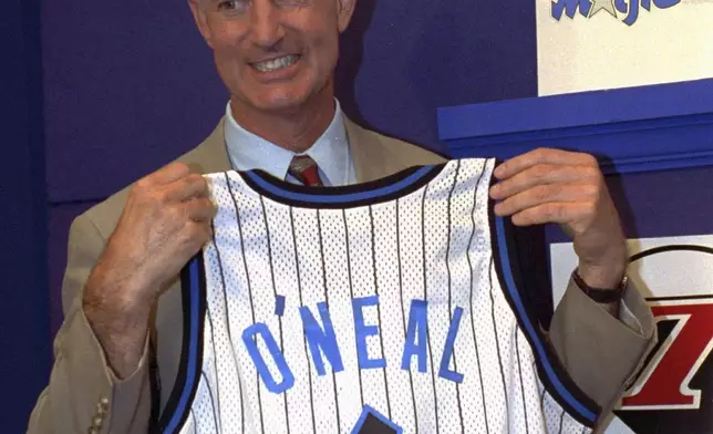 FILE - Orlando Magic President and General manager Pat Williams grins while holding up a jersey bearing the name O'Neal and the number 1, at the NBA draft lottery in Secaucus, N.J. May 17, 1992. (AP photo/Bill Kostroun, File)