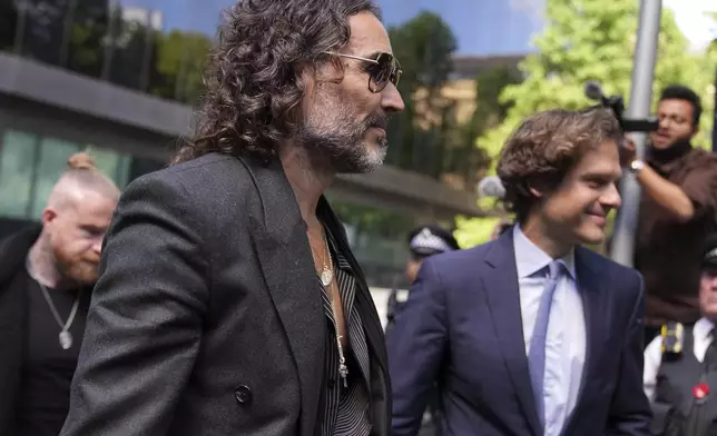 English comedian and actor Russell Brand arrives at Southwark Crown Court where he is charged with rape and sexual assault in London, Friday, May 30, 2025.(AP Photo/Alastair Grant)