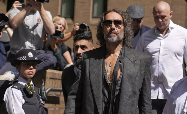 English comedian and actor Russell Brand leaves Southwark Crown Court where he is charged with rape and sexual assault in London, Friday, May 30, 2025.(AP Photo/Alastair Grant)