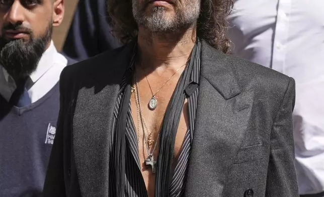 English comedian and actor Russell Brand leaves Southwark Crown Court where he is charged with rape and sexual assault in London, Friday, May 30, 2025.(AP Photo/Alastair Grant)