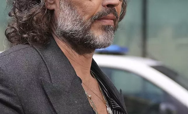English comedian and actor Russell Brand arrives at Southwark Crown Court where he is charged with rape and sexual assault in London, Friday, May 30, 2025.(AP Photo/Alastair Grant)