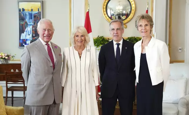 From left, Britain's King Charles, Queen Camilla, Canada's Prime Minister Mark Carney and his wife Diana Fox Carney pose for a family portrait at Rideau Hall in Ottawa, Ontario, during a royal visit Monday, May 26, 2025. (Sean Kilpatrick/The Canadian Press via AP)