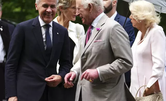 Canada's Prime Minister Mark Carney, left, greets Britain's King Charles as he arrives at Rideau Hall in Ottawa, Ontario, during a royal visit Monday, May 26, 2025. (Sean Kilpatrick/The Canadian Press via AP)