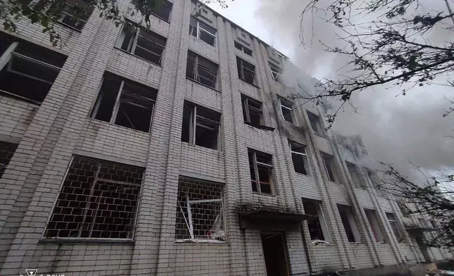 In this photo provided by the Ukrainian Emergency Services on May 7, 2025, smoke rises from a building damaged by a Russian strike in Uman, Ukraine. (Ukrainian Emergency Service via AP)