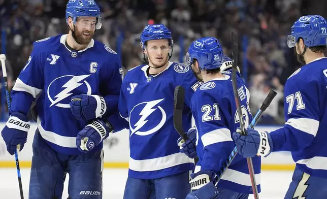 Tampa Bay Lightning center Jake Guentzel (59) celebrates his goal against the Florida Panthers with defenseman Victor Hedman (77), center Brayden Point (21) and center Anthony Cirelli (71) during the second period in Game 5 of an NHL hockey Stanley Cup first-round playoff series, Wednesday, April 30, 2025, in Tampa, Fla. (AP Photo/Chris O'Meara)