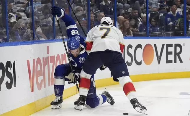 Florida Panthers defenseman Dmitry Kulikov (7) takes down Tampa Bay Lightning center Zemgus Girgensons (28) during the second period in Game 5 of an NHL hockey Stanley Cup first-round playoff series, Wednesday, April 30, 2025, in Tampa, Fla. (AP Photo/Chris O'Meara)