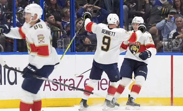 Florida Panthers center Sam Bennett (9) celebrates his goal against the Tampa Bay Lightning with center Anton Lundell (15) during the second period in Game 5 of an NHL hockey Stanley Cup first-round playoff series, Wednesday, April 30, 2025, in Tampa, Fla. (AP Photo/Chris O'Meara)
