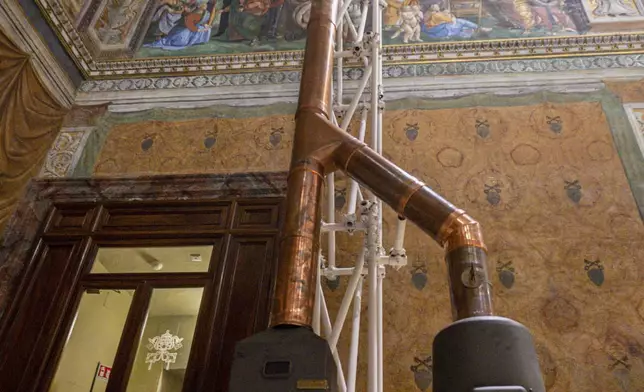 This image taken on Friday, May 2, 2025, and made available Saturday, May 3, 2025, by Vatican Media, shows a temporary stove inside the Sistine Chapel at the Vatican that will release smoke signals—black or white—from the upcoming conclave starting May 7, indicating whether a new pope has been elected. (Vatican Media via AP)