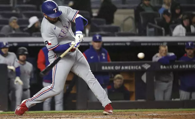 Texas Rangers' Jake Burger hits a home run during the fifth inning of a baseball game against the New York Yankees, Wednesday, May 21, 2025, in New York. (AP Photo/Pamela Smith)