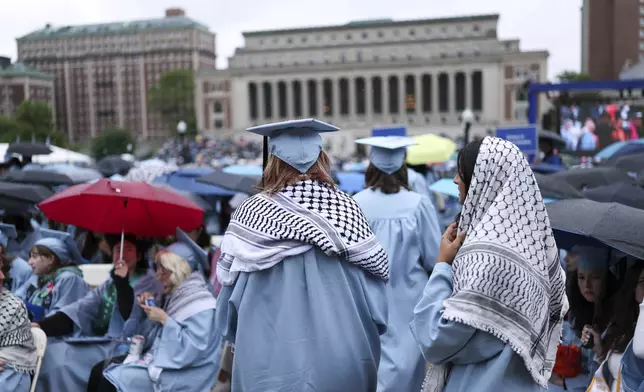 Students wear keffiyeh scarfs before the Columbia University commencement ceremony on Columbia's main campus, in Manhattan, on Wednesday, May 21, 2025 in New York. (Charly Triballeau/Pool Photo via AP)
