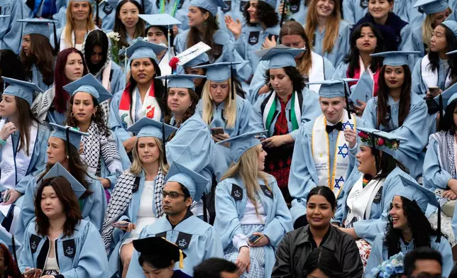 Graduates participate in a graduation ceremony at Columbia University in New York, Wednesday, May 21, 2025. (AP Photo/Seth Wenig, Pool)