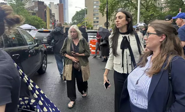 Defense attorney Teny Geragos, center, exits court during the Sean "Diddy" Combs' sex trafficking trial, Tuesday, May 13, 2025. (AP Photo/Ted Shaffrey)