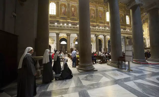 Nuns prays during a mass in Santa Maria in Trastevere church, in central Rome, Sunday, May 4, 2025. (AP Photo/Alessandra Tarantino)