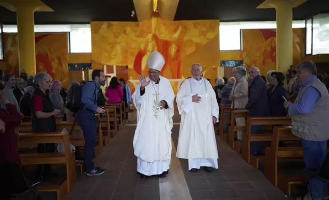 Cardinal Oswald Gracias, left, leaves after leading a mass in San Paolo Della Croce parish church in Corviale neighbourhood, in Rome, Sunday, May 4, 2025. (AP Photo/Alessandra Tarantino)