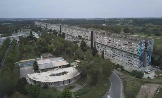 An areal view of San Paolo Della Croce parish church next to "Corviale" a 958-meter long public housing building in Rome, Sunday, May 4, 2025. (AP Photo/Alessandra Tarantino)