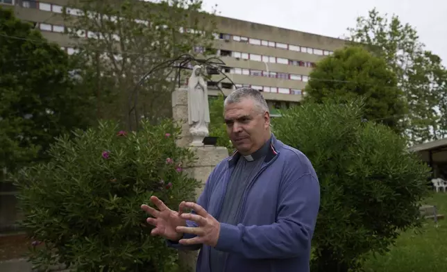 Father Roberto Cassano attends an interview in San Paolo Della Croce parish church in Corviale neighbourhood, in Rome, Sunday, May 4, 2025. (AP Photo/Alessandra Tarantino)