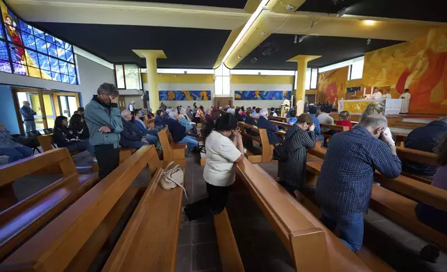 Faithful pray during a mass in San Paolo Della Croce parish church in Corviale neighbourhood, in Rome, Sunday, May 4, 2025. (AP Photo/Alessandra Tarantino)