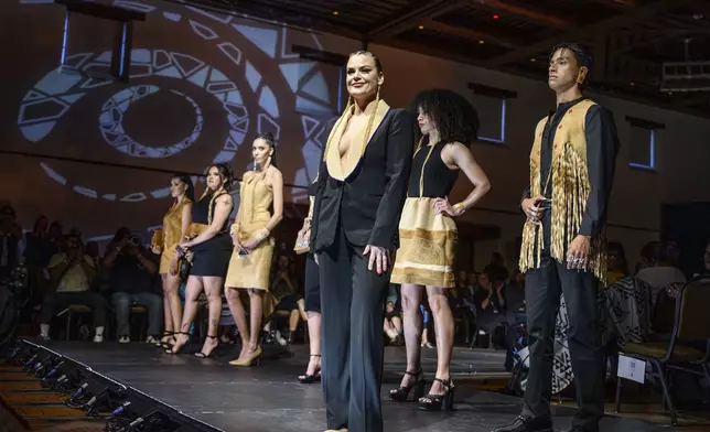 Designer Randi Nelson takes the stage after her runway show at the 2025 Native Fashion Show, Friday, May 9, 2025, in Santa Fe, N.M. (AP Photo/Roberto E. Rosales)