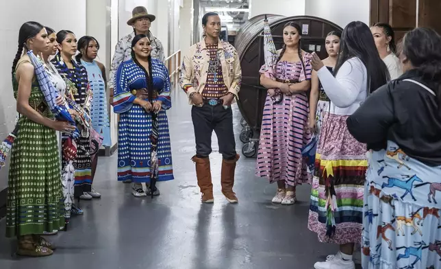 Models prepare to take the runway for the 2025 Native Fashion Show, Friday, May 9, 2025, in Santa Fe, N.M. (AP Photo/Roberto E. Rosales)