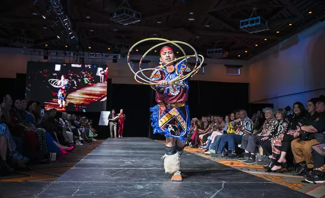 Kevin Dakota Duncan, of Phoenix, performs a hoop dance before models take to the runway at the 2025 Native Fashion Show, Friday, May 9, 2025, in Santa Fe, N.M. (AP Photo/Roberto E. Rosales)