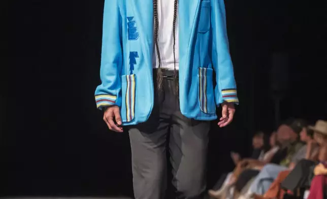 A model wears a design by Sage Mountainflower on the runway at the 2025 Native Fashion Show, Friday, May 9, 2025, in Santa Fe, N.M. (AP Photo/Roberto E. Rosales)