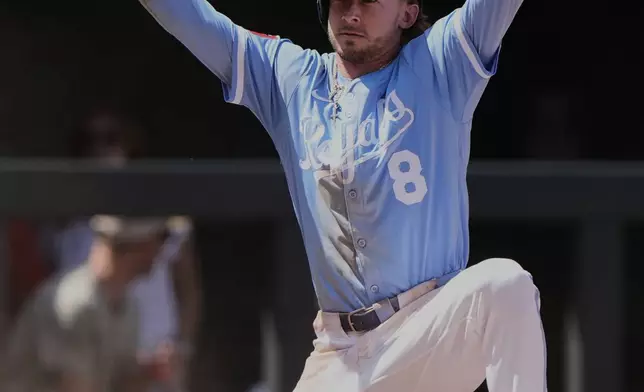 Kansas City Royals' Drew Waters (8) celebrates on third after hitting a triple during the seventh inning of a baseball game against the St. Louis Cardinals, Sunday, May 18, 2025, in Kansas City, Mo. (AP Photo/Charlie Riedel)