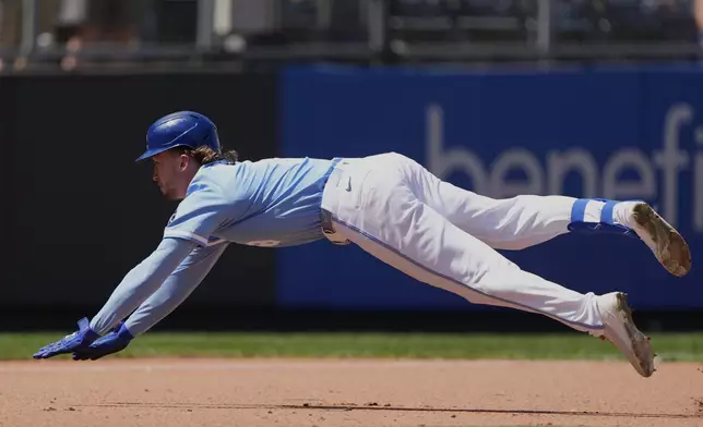 Kansas City Royals' Drew Waters dives to third after hitting a triple during the seventh inning of a baseball game against the St. Louis Cardinals, Sunday, May 18, 2025, in Kansas City, Mo. (AP Photo/Charlie Riedel)