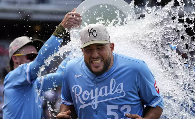 Kansas City Royals relief pitcher Carlos Estevez is doused by teammates after their baseball game against the St. Louis Cardinals, Sunday, May 18, 2025, in Kansas City, Mo. (AP Photo/Charlie Riedel)