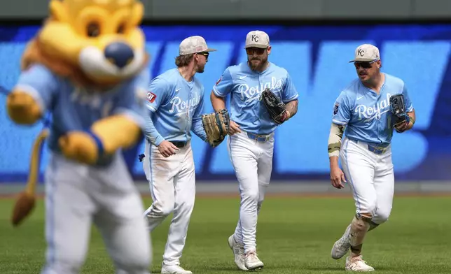 Kansas City Royals outfielders Drew Waters, left, Kyle Isbel, center, and Hunter Renfroe celebrate after their baseball game against the St. Louis Cardinals, Sunday, May 18, 2025, in Kansas City, Mo. (AP Photo/Charlie Riedel)