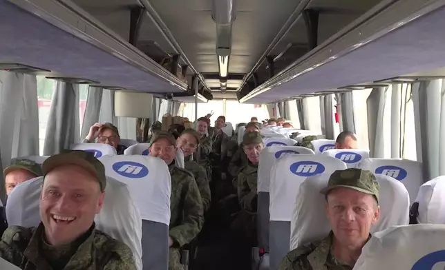 In this photo taken from a video released by Russian Defense Ministry press service, Russian servicemen ride a bus after returning from captivity following an exchange between Russia and Ukraine, at an undisclosed location in Belarus, Friday, May 23, 2025. (Russian Defense Ministry Press Service via AP)