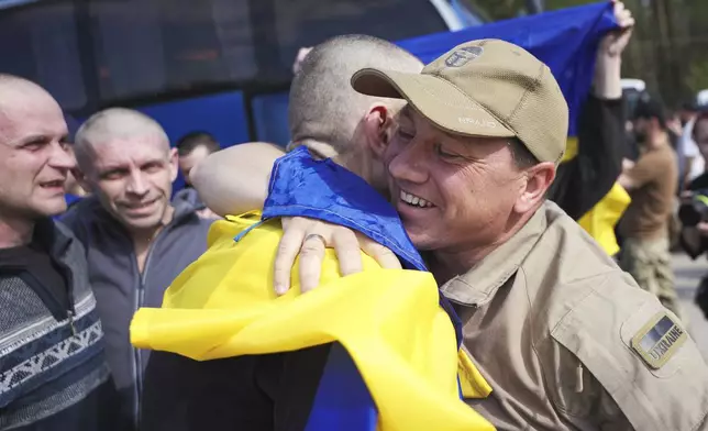 In this photo provided by the Ukrainian Presidential Press Office, a Ukrainian soldier hugs his comrade after returning from captivity during an exchange between Russia and Ukraine, in Chernyhiv region, Ukraine, Friday, May 23, 2025. (Ukrainian Presidential Press Office via AP)