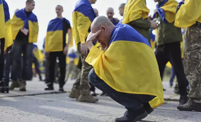 A Ukrainian soldier reacts after returning from captivity following an exchange between Russia and Ukraine, in Chernyhiv region, Ukraine, Friday, May 23, 2025. (AP Photo)