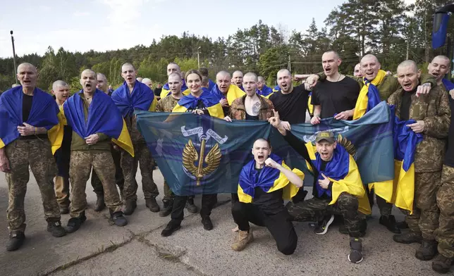 In this photo provided by the Ukrainian Presidential Press Office,Ukrainian soldiers pose after returning from captivity during an exchange between Russia and Ukraine, in Chernyhiv region, Ukraine, Friday, May 23, 2025. (Ukrainian Presidential Press Office via AP)