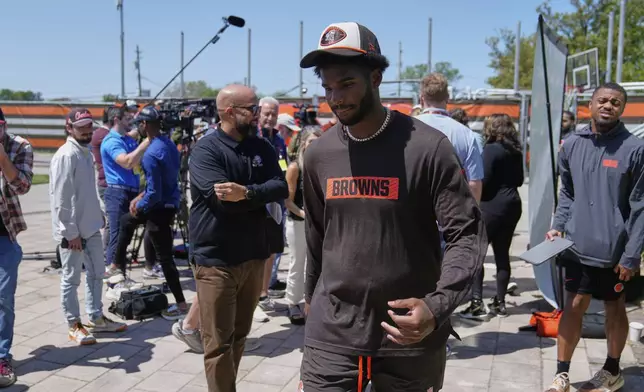 Cleveland Browns quarterback Shedeur Sanders (12) leaves a news conference during the NFL football team's rookie minicamp in Berea, Ohio, Saturday, May 10, 2025. (AP Photo/Sue Ogrocki)