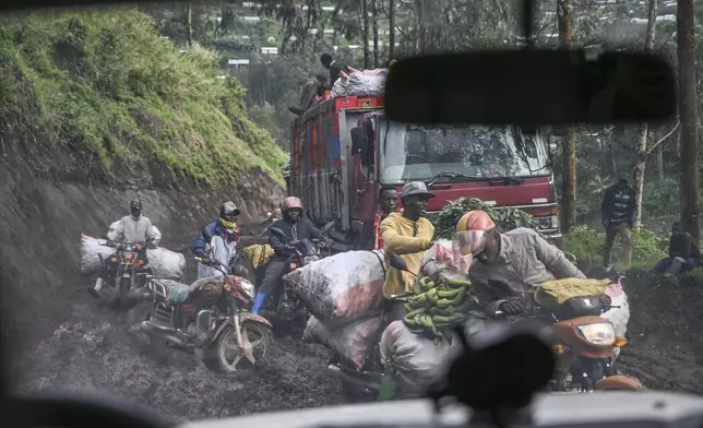 Motorcyclists ride through thick mud on their way to the mining town of Rubaya, Democratic Republic of Congo, on Friday, May 9, 2025. (AP Photo/Moses Sawasawa)
