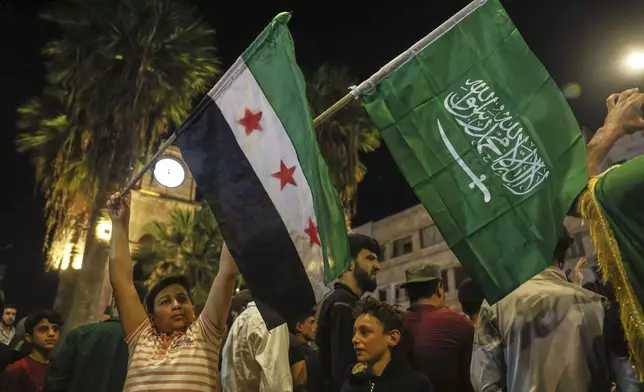 Syrians celebrate after U.S. President Donald Trump announced plans to ease sanctions on Syria and move toward normalizing relations with its new government to give the country 'a chance at peace,' in Idlib, Syria, Tuesday, May 13, 2025. (AP Photo/Ghaith Alsayed)
