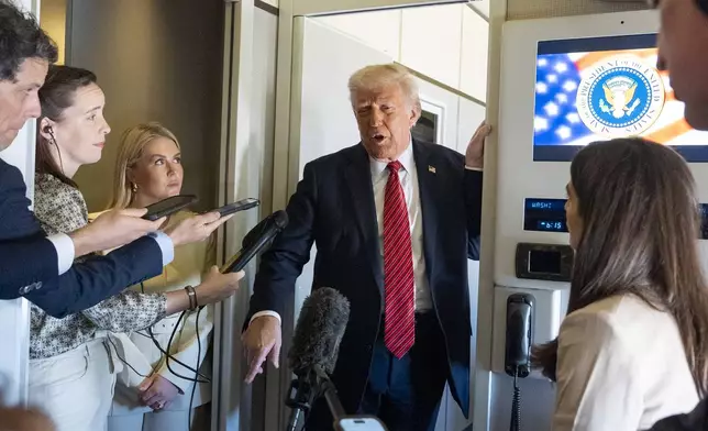 President Donald Trump speaks to reporters aboard Air Force One en route from Riyadh, Saudi Arabia to Doha, Qatar, Wednesday, May 14, 2025. (AP Photo/Alex Brandon)