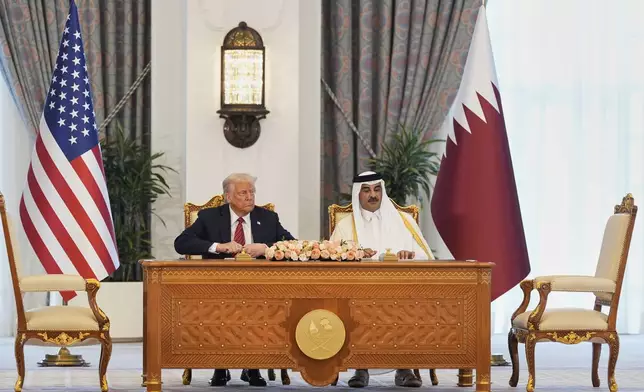 President Donald Trump and Qatar's Emir Sheikh Tamim bin Hamad Al Thani attend a signing ceremony at the Amiri Diwan in Doha, Qatar, Wednesday, May 14, 2025. (AP Photo/Alex Brandon)