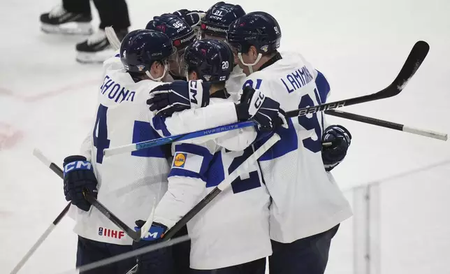 Finland's Eeli Tolvanen (20) celebrates with teammates after scoring against the United States during the first period of a quarterfinal match at the ice hockey world championships in Stockholm, Sweden, Thursday, May 22, 2025. (AP Photo/Petr David Josek)