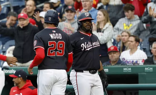 Washington Nationals' James Wood (29) is greeted by Josh Bell after scoring a run on a double hit by Keibert Ruiz against Atlanta Braves pitcher AJ Smith-Shawver during the first inning of a baseball game in Washington, Thursday, May 22, 2025. (AP Photo/Terrance Williams)
