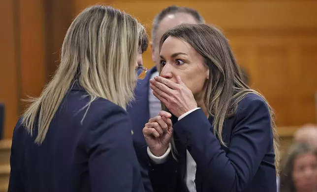 Karen Read, right, and lawyer Elizabeth Little discuss developments during Read's murder trial in Norfolk Superior Court in Dedham, Mass., Wednesday, May 21, 2025. (Greg Derr/The Patriot Ledger via AP, Pool)