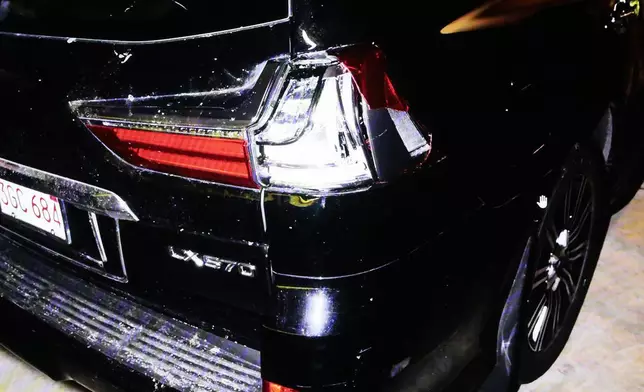 A photo of Karen Read's SUV, parked in the Canton Police Department's sally port, is projected during her murder retrial showing pieces missing from the right, rear taillight, in Norfolk Superior Court, Monday, May 12, 2025, in Dedham, Mass. (Pat Greenhouse/The Boston Globe via AP, Pool)
