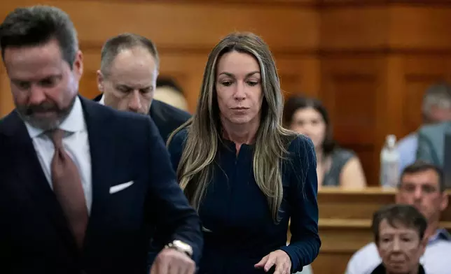 With her defense attorneys Alan Jackson, left, and David Yannetti, Karen Read returns to the defense table during her murder retrial in Norfolk Superior Court, Monday, May 12, 2025, in Dedham, Mass. (Pat Greenhouse/The Boston Globe via AP, Pool)