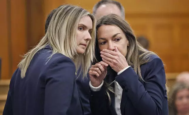 Karen Read, right, and lawyer Elizabeth Little discuss developments during Read's murder trial in Norfolk Superior Court in Dedham, Mass., Wednesday, May 21, 2025. (Greg Derr/The Patriot Ledger via AP, Pool)