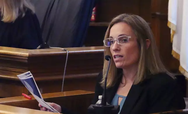 Mass. State Police forensic scientist Maureen Hartnett looks over photo evidence under cross examination at the Karen Read case at Norfolk Superior Court, Wednesday, May 14, 2025, in Dedham, Mass. (Mark Chavous/Enterprise News via AP, Pool)
