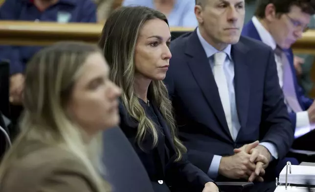Defendant Karen Read, center, and defense lawyer David Yannetti, right, listen as Massachusetts State Police Sgt. Yuriy Bukhenik testifieds during the Karen Read murder trial in Norfolk Superior Court in Dedham, Mass., Friday, May 9, 2025. (Mark Stockwell/The Sun Chronicle via AP, Pool)