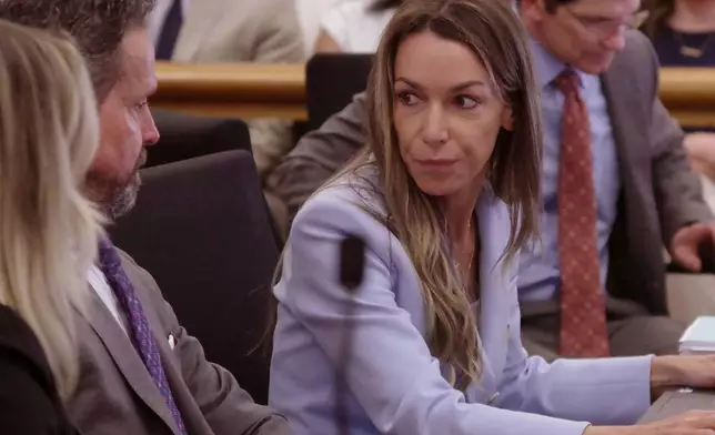 Defendant Karen Read talks with her attorneys during her murder trial in Norfolk Superior Court in Dedham, Mass., Wednesday, May 14, 2025. (Mark Chavous/Enterprise News via AP, Pool)