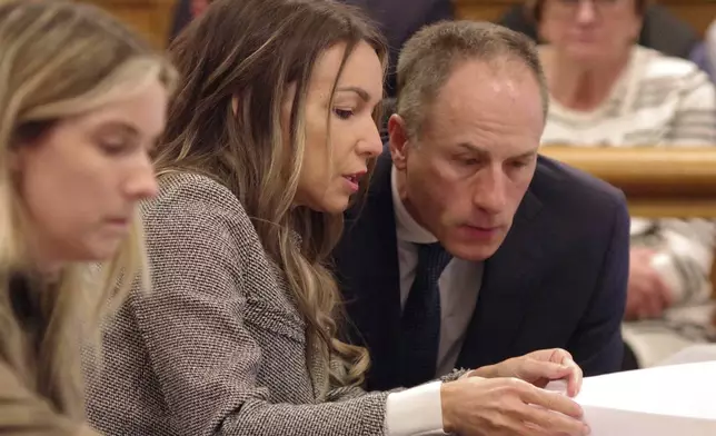 Karen Read confers with attorney David Yannetti during her trial at Norfolk Superior Court in Dedham, Mass., Friday, May 2, 2025. (Mark Jarret Chavous/The Enterprise via AP, Pool)