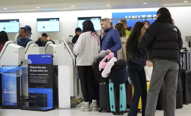 Travelers check into their flights at Newark Liberty International Airport in Newark, N.J., Monday, May 5, 2025. (AP Photo/Seth Wenig)